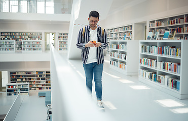 Image showing Student walking in library with phone for university, education or college website, internet search and academy faq, about us or contact. Campus, cellphone and teenager reading scholarship newsletter