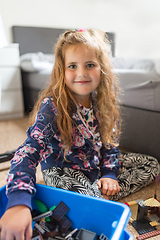 Image showing Smiling cute girl with long curly golden hair