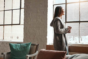 Image showing Relax, coffee and woman looking out window from her home, thinking and daydreaming on a quiet morning. Daydream, tea and girl staring, contemplating and resting in her her living room on the weekend