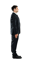 Image showing Serious, successful and young businessman standing isolated on a white background in a studio. Side profile, confident and office worker in a suit for work on a studio background with mockup space