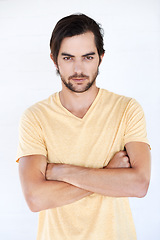 Image showing Man, arms crossed and serious fashion portrait isolated on a white background with mockup space. Face of male Europe model with a beard posing for magazine cover, advertising or marketing in studio