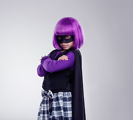 Image showing Portrait, girl and mask for costume, hero and confident kid isolated on grey studio background. Face cover, female child and superhero with confidence, dress up and fantasy for cosplay and creative