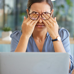Image showing Tired corporate woman, laptop and eye pain with hands, glasses and stress at desk in finance office. Burnout, executive leader and headache by computer with mental health, problem or anxiety in Dubai