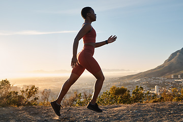 Image showing Running, mountain and black woman athlete for fitness, workout or speed in morning sunrise. Nature training, run and runner for cardio exercise, performance or summer sunshine by mountains trail road