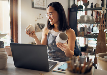 Image showing Asian woman, laptop and pottery business with smile for creative startup holding ceramic creation in the workshop. Happy woman business owner smiling for art, design or clay craft by computer at work