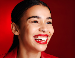 Image showing Woman, makeup and smile with lipstick in studio for beauty, cosmetics or self love with glow face. Model, natural cosmetic shine or skin wellness for self care, health and aesthetic by red background