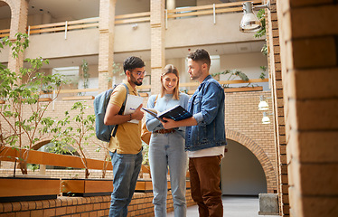 Image showing University, students and friends with study book for project, education or sharing information together at the campus. Group of college people reading textbook with smile for learning or scholarship