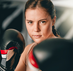 Image showing Boxer, portrait or woman training for fitness in cardio workout or exercise with boxing gloves or focus at gym. Face, girl fighter or healthy sports athlete with courage, power or strong mindset