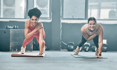 Image showing Woman, fitness and friends in class on mat for workout, exercise or training at the gym. Portrait of happy women with smile for healthy exercising balancing on arm for plank or cardio at gymnasium