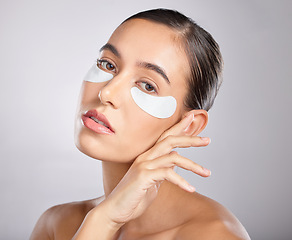 Image showing Skincare, eye patch and portrait of woman with beauty product for self care, anti aging and wellness. Facial healthcare, spa salon and aesthetic model face with makeup cosmetics on studio background