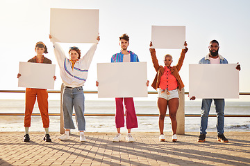 Image showing Portrait, poster and diversity with friends together holding signage in protest on the promenade by the sea. Freedom, mockup and billboard with a man and woman friend group holding blank sign boards