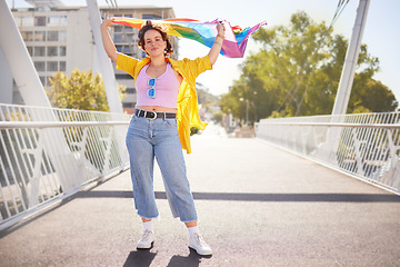 Image showing Rainbow, flag and lgbt woman portrait of a person with human rights, sexuality and equality support. Freedom, smile and gen z female on a urban city bridge with celebration of lgbtq with happiness