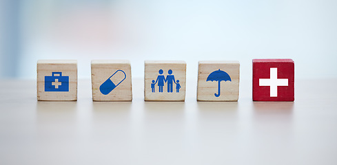 Image showing Healthcare, insurance and wooden blocks in studio on an empty gray background for safety or security. Abstract, medicine and health with block toys in a hospital or clinic for medical care