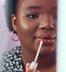 Image showing Black woman, makeup and lipstick for beauty, cosmetics or glow and gloss for facial treatment in the bathroom. African American female applying cosmetic product to lips or mouth with stick brush