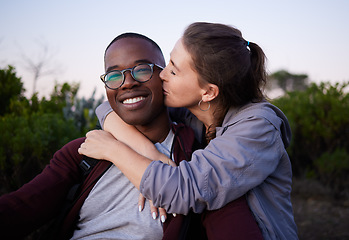 Image showing Kiss, interracial and portrait of a couple in nature for a date, walk or bonding in Portugal. Love, affection and black man and woman together with a romantic hug in a park or field to relax