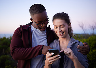 Image showing Hiking, travel and couple with phone on mountain for location, gps mobile app and health tracking. Fitness, dating and interracial man and woman with smartphone for adventure, freedom and nature hike