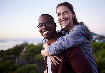 Image showing Love, nature and portrait of interracial couple on mountain for holiday, vacation and adventure on weekend together. Travel, dating and happy man piggyback woman enjoy calm, outdoor freedom and peace