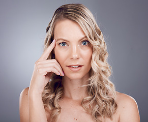 Image showing Face portrait, beauty skincare and woman in studio isolated on a gray background. Makeup, cosmetics and aesthetics of female model with healthy, glowing and flawless skin after spa facial treatment