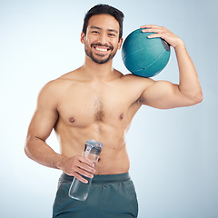 Image showing Fitness, portrait and medicine ball with a sports man in studio for health or natural body. Water bottle, face and exercise with a male athlete training for a healthy lifestyle with gym equipment