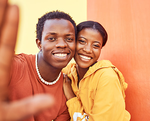 Image showing Selfie, love and memories with a black couple posing for a photograph together on a color wall background. Portrait, happy and smile with a man and woman taking a picture while bonding outside