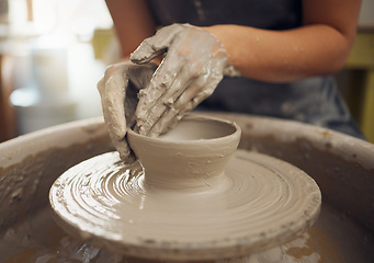 Image showing Hands, clay and pottery with a woman designer working in a studio or workshop for art, design and ceramics. Creative, sculpture and wheel with a female artist at work as a potter or ceramic artisan