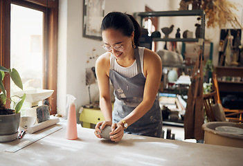 Image showing Small business, art and pottery girl entrepreneur in workshop with clay for creativity and inspiration. Creative asian woman working at artistic workspace with happy smile in Tokyo, Japan