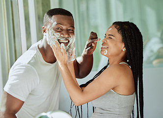 Image showing Shaving, playful and fun with a black couple laughing or joking together in the bathroom of their home. Love, shave and laughter with a man and woman being funny while bonding in the morning