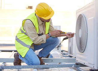 Image showing Air conditioning, technician or engineer on roof for maintenance, building or construction of fan hvac repair. Air conditioner, handyman or worker with tools working on a city development project job