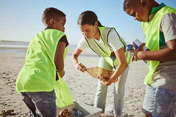 Image showing Plastic bottle, beach and woman with children recycling, cleaning and learning, education and community for pollution. Mother or teacher with kids and recycling teamwork, project goals and earth day