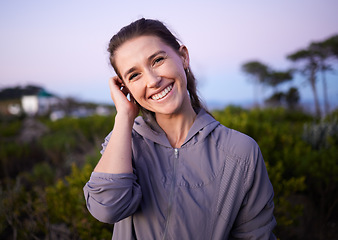 Image showing Happy, beautiful and portrait of a woman in nature during sunset for peace, calm and zen. Adventure, hike and smile of a girl on a walk for fitness, cardio and relaxing during dawn in a park