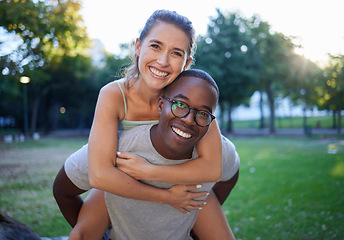 Image showing Portrait, love and piggyback with an interracial couple together outdoor in a park for bonding or a date. Summer, diversity and smile with a man and woman happy outside in nature while dating