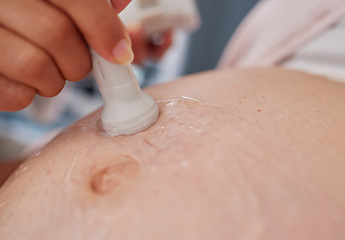 Image showing Doctor hand, ultrasound and pregnancy stomach for reading, health and family planning for future mother. Zoom closeup of medic, pregnant woman and sonogram with medical tech on abdomen for healthcare