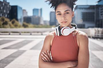 Image showing Fitness, headphones and black woman in portrait for workout, exercise or training motivation, mental health and wellness in city. Face of a sports athlete with music audio subscription or technology