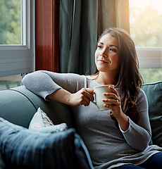 Image showing Happiness, coffee and woman thinking, sofa and relax on weekend, break and female in living room. Young lady, girl and tea in lounge on couch, daydreaming and thoughts with ideas, focus and fantasy