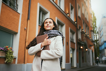 Image showing Business woman, tablet and thinking in the city of a freelance travel writer by buildings. Writing idea, technology and worker by a urban building with a happy smile about holiday traveling for work