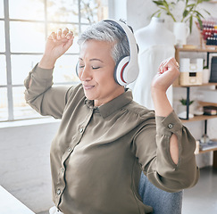 Image showing Dance, headphones and music by senior business woman in office, happy and excited about small business. Earphones, dancing and elderly female celebrate in design studio, cheerful and positive at desk