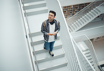 Image showing Library search, geek student or intelligent man for phd research, creative vision and knowledge in university. College, stairs above and person thinking of books for education, scholarship or study