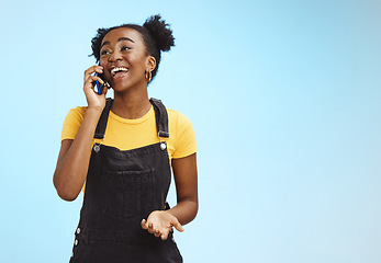 Image showing Communication, happy and talking black woman on a phone call isolated on a blue background. Contact, smile and thinking African girl in conversation on a mobile with mockup space on a studio backdrop