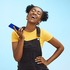 Image showing Phone, fashion and black woman laugh on blue background for social media, internet and chat mockup. Communication, advertising and happy girl on call, talking and laughing with smartphone in studio