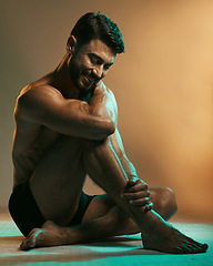 Image showing Fitness, wellness and man in neon studio with smile for exercise, bodybuilder training and workout. Beauty, skincare and male model in underwear on floor with muscles, sports goals and motivation