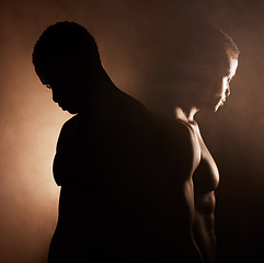 Image showing Black man, dark studio and muscle silhouette reflection with thinking, depression and mental health with shadow. Man, art aesthetic and smoke with strong body, alone and struggle with anxiety problem