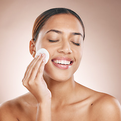 Image showing Beauty, woman and cotton pad with face and facial treatment, wellness and happy cleaning with skincare mockup. Skin, natural cosmetics and makeup removal, cosmetic care against studio background