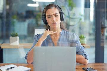 Image showing Business woman, laptop and headphones for a webinar, video conference or video call on zoom in a office. Entrepreneur serious while talking at computer screen for training, learning or online meeting