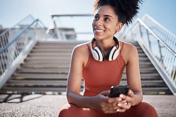 Image showing Fitness, headphones and smartphone with woman on stairs thinking of workout, exercise or training website, blog or social media. Mental health technology, sports music and happy black woman in city