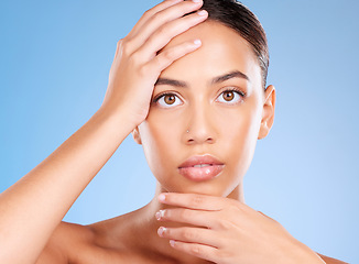 Image showing Portrait, skincare or model in studio after beauty or facial grooming routine on a blue background with mockup space. Luxury, healthy girl or beautiful woman touching face for self love or self care