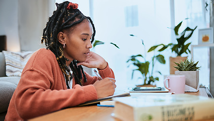 Image showing Studying, student and black woman writing in notebook for education, learning and notes for academic class. University, college and girl focus, busy and thinking for homework, assignment and project