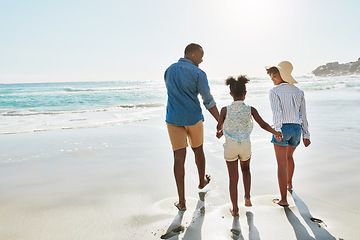 Image showing Black family, beach and walk during summer on vacation or holiday relaxing and enjoying peaceful scenery at the ocean. Sea, water and parents with daughter, child or kid with childhood freedom