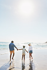 Image showing Beach vacation and couple with child walking in water while holding hands together with love in summer from the back. Nature, ocean and blue sky, black family on tropical island holiday in Maldives.