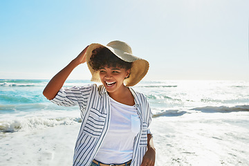 Image showing Sunshine, black woman and beach for holiday, relax and fun on trip, travelling or carefree in summer. African American female, lady or seaside vacation, water and stress relief with freedom and ocean