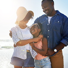 Image showing Smile, hug and happy with black family at beach for summer break, support and tropical vacation. Peace, travel and happiness with parents and daughter playing by the ocean for freedom, sea and care